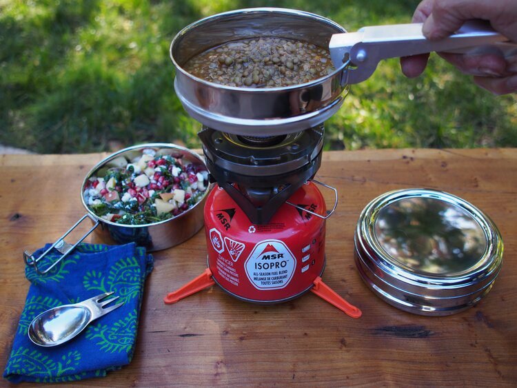 cooking-on-camp-stove - equipment needed on a motorcycle tour