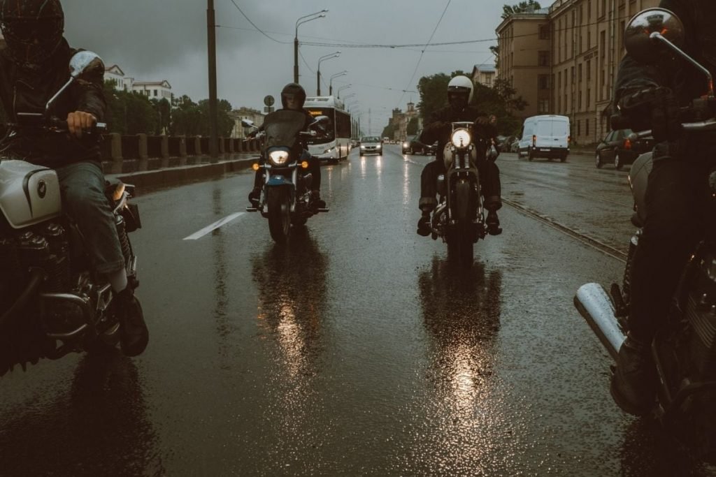 motorcycle touring rain gear - bikers in rain shower