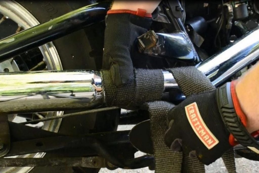 mechanic fitting exhaust heat wrap