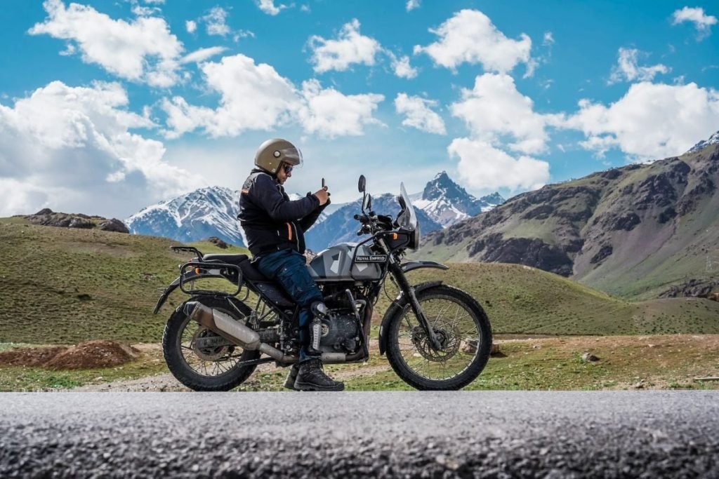 lone rider in mountains - group motorcycle riding