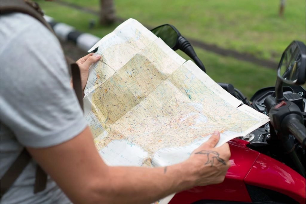biker reading map - group motorcycle riding