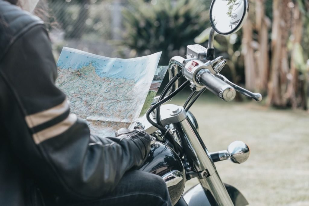 rider on motorbike checking map