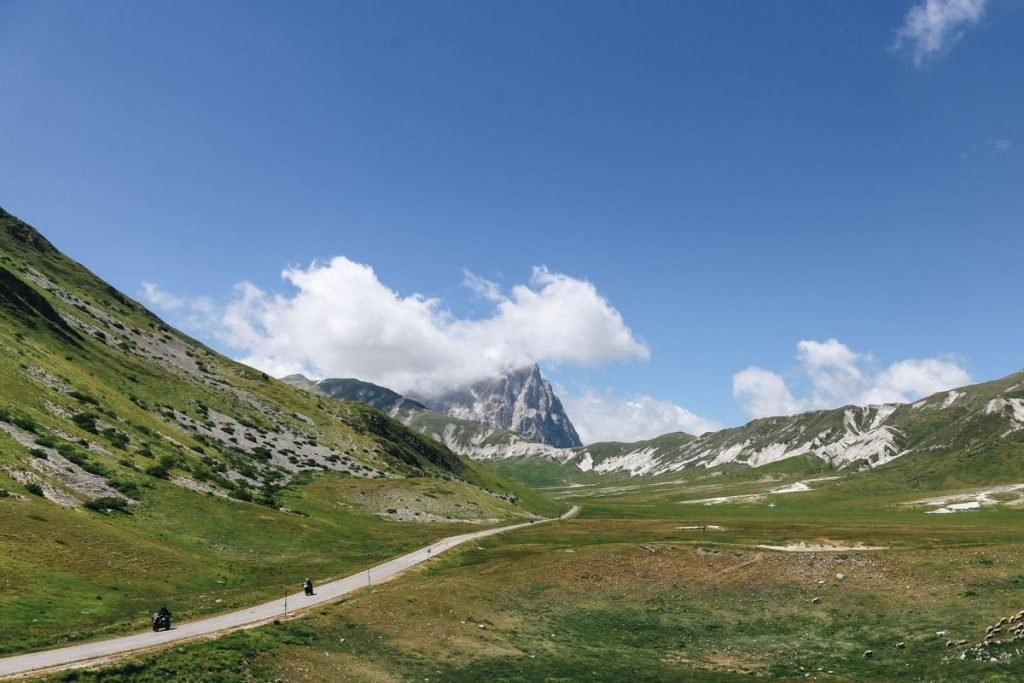 plan long-distance motorcycle - bikers on isolated roads with mountains
