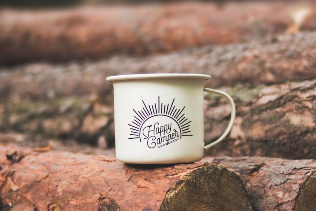 hamper camper mug on logs