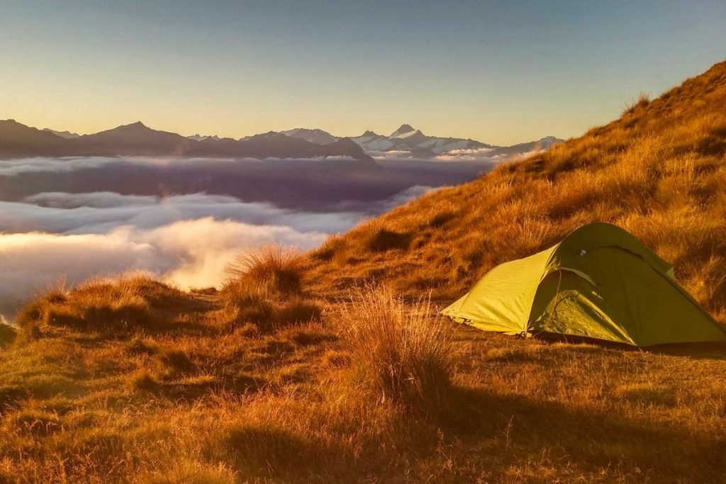 camping motorcycle - yellow tent with cloud inversion