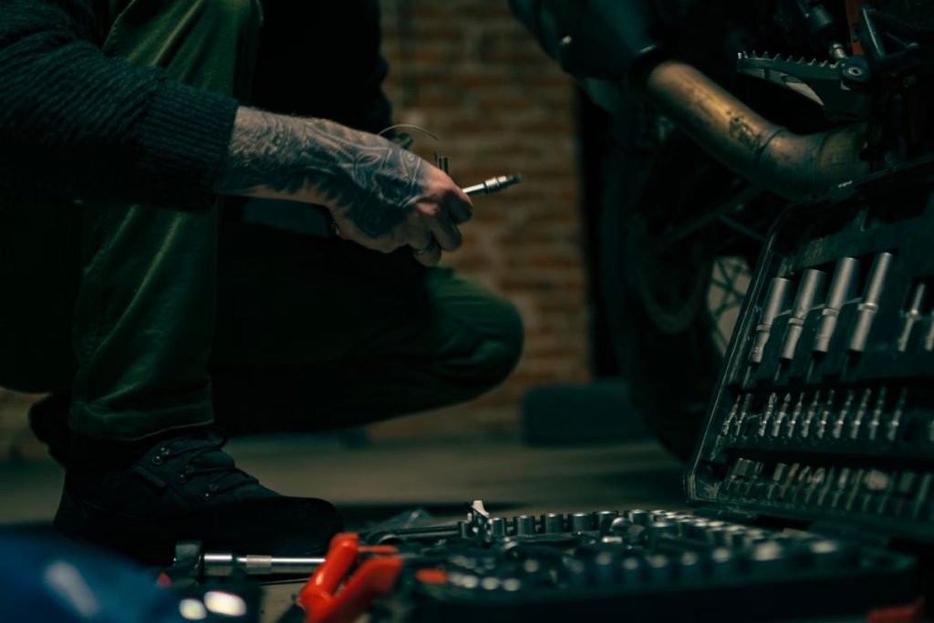 preparing motorcycle for tour - mechanic with tools