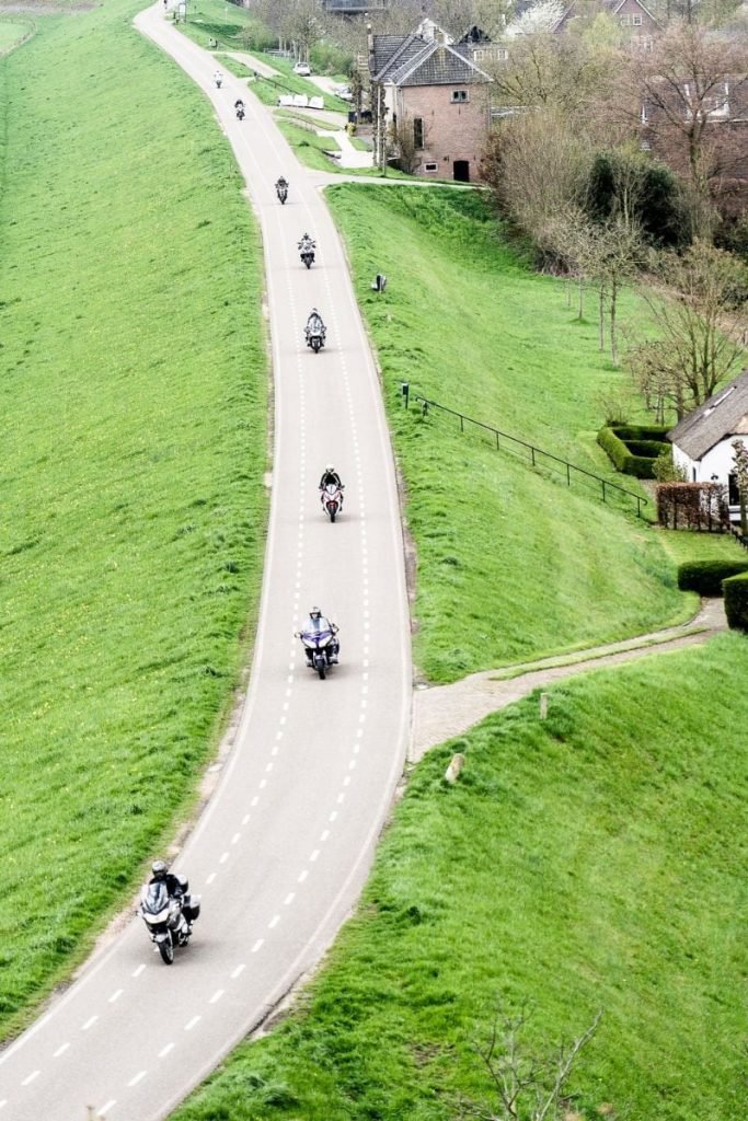 group of riders on narrow road
